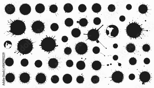A collection of black ink splatters, with various shapes and sizes, on a clean white background