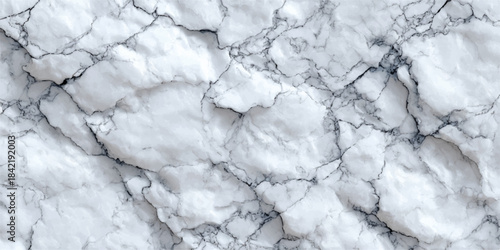 Abstract close up of a white marble surface with subtle grey veining and natural texture