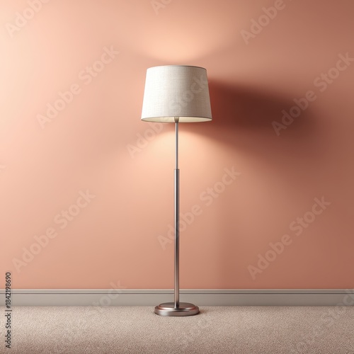 A tall floor lamp with a textured white shade and a silver pole is positioned against a salmon pink wall, casting soft shadows.