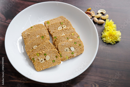 Til gajak, a traditional Indian winter sweet made with sesame seeds, jaggery, ghee, and dryfruits. Crunchy til chikki festive treat for Makar Sankranti. Tilgul. sesame candy. Copy Space. Winter food.