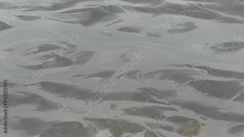 Wind eroded snow bedforms in Iceland, where sastrugi‑like ridges and ripples produced by aeolian transport and sublimation form elongated microdunes aligned with the prevailing wind direction.