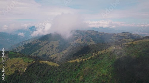Cinematic video showcasing the majestic cloud forest mountains of the Ecuadorian Andes, near Baños de Agua Santa. Includes lush aerial landscapes and local rural wildlife.
