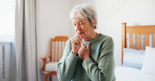Fotografi Cough, sick and senior woman on bed in home with allergies, chest infection or sore throat