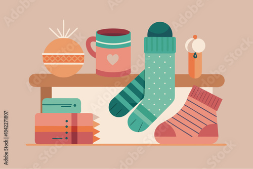 Cozy winter arrangement with warm socks, books, mug and candle in soft pastel colors