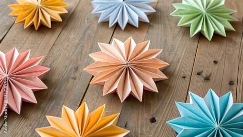 Beautiful Origami Paper Snowflakes Crafted from Colorful Art Pages Artistically Scattered Across a Rustic Wooden Tabletop Creating a Playful Handmade Winter Craft Scene Full of Creativity