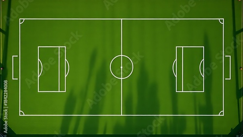 Aerial view of a geometric green football field from above.