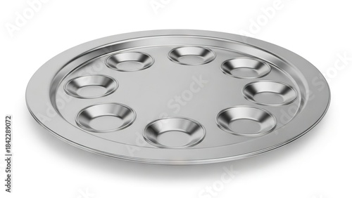 Metal escargot dish with eight depressions arranged symmetrically on a flat round surface