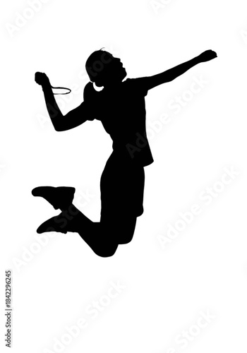 Silhouette of a female badminton player jumping to hit the shuttlecock