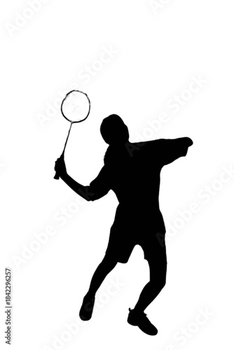 Silhouette of a male badminton player executing an overhead smash shot with a racket
