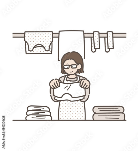 洗濯物をたたむ40代女性のイラスト