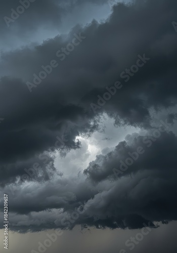 A dramatic and turbulent sky filled with heavy, dark grey storm clouds signaling imminent severe weather and rainfall ,powerful ,impending ,weather