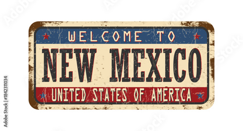 Welcome to New Mexico. An old worn sign with an inscription. Welcome metal plaque with rust elements