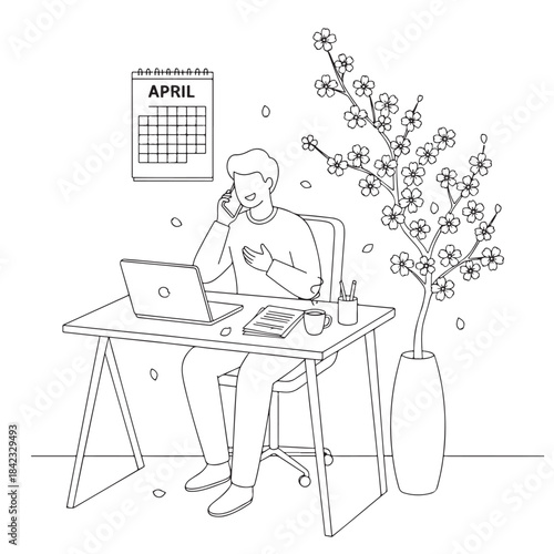 A man is sitting at a desk with a laptop and a cell phone. He is talking on the cell phone while working on the laptop. The room has a calendar on the wall and a potted plant in the corner