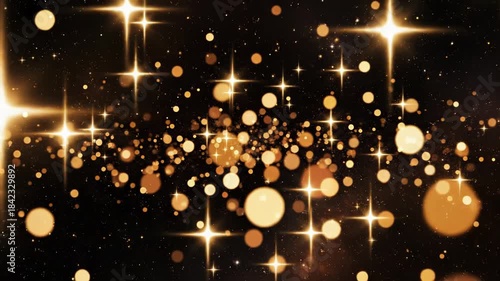 Abstract sparkling gold light particles and points of illumination on dark background