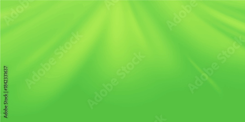 Abstract green background with soft light rays and smooth blurred motion waves creates a nature-inspired gradient texture for a modern wallpaper design