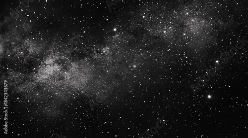 A stunning black and white image captures the vast expanse of the Milky Way galaxy, revealing a dense region of star formation and countless stars scattered across the dark void of space.