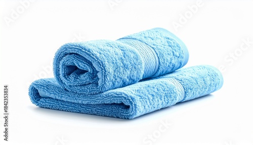 Two blue towels—one rolled, one folded—on light surface.