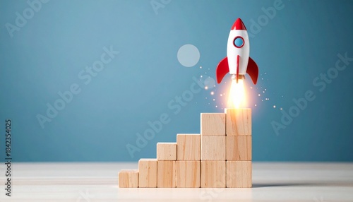 Toy rocket launching from wooden steps on blue background.