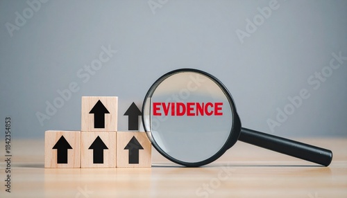 Wooden blocks ascending with magnifying glass revealing “EVIDENCE”.