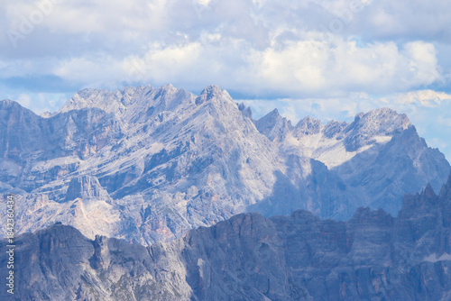 Aerial view of Dolomite peaks in Italy, shrouded by dramatic rainy clouds and alpine mystery