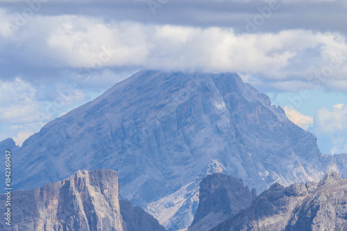Aerial view of Sorapis Peak in the Dolomites, Italy, shrouded by dramatic rainy clouds