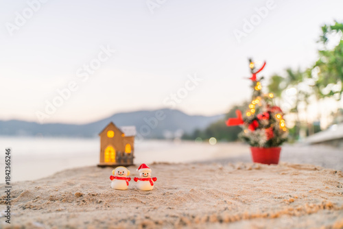 Santa Claus Doll Cute and Christmas Tree House Relaxing on the Beach. Merry Christmas Holiday. Bright Background. Patong Beach, Phuket, Thailand.
