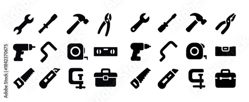 Silhouette icons of various hand and power tools for constructio