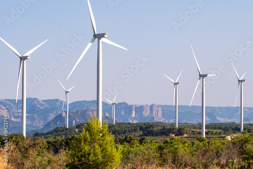 Aerial drone view of windmill renewable energy wind farm with green energy sustainability in rural landscape of Terra Alta Catalonia Spain on a sunny calm day