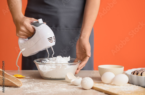 Woman whipping egg whites w...