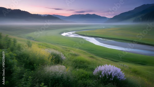 Fototapeta Naklejka Na Ścianę i Meble -  Sunrise over mountains and a calm river reflecting the sky in a peaceful green summer landscape