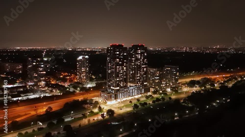 Wallpaper Mural Nighttime aerial view of Parklawn’s condo towers overlooking Lake Ontario, with glowing city lights and highway traffic leading toward downtown Toronto’s skyline. Torontodigital.ca