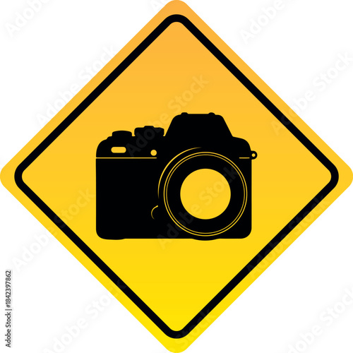 Camera warning sign black silhouette of a DSLR camera on a yellow diamond background representing photography zone or no entry for unauthorized