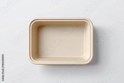 A simple, ecofriendly rectangular food container on a light gray background, emphasizing sustainability. Snack container mockup