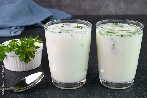 Photos Serving buttermilk drink in glass cups.