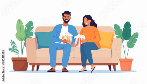 Happy couple enjoying a relaxed movie night at home on the sofa, sharing popcorn and a cozy evening together with a smile