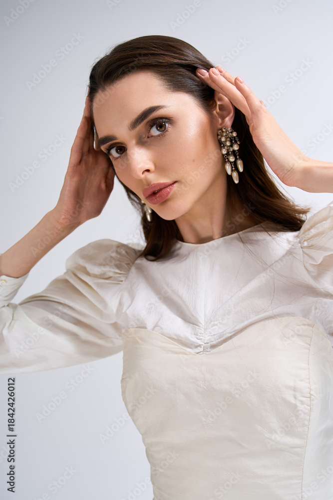 Obraz premium Elegant bride expresses blissful emotions before a wedding ceremony in a chic setting