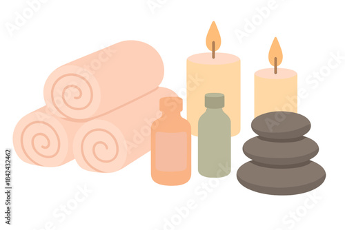 Rolled soft towels, glowing scented candles, stacked massage stones, and oil bottles for spa treatment