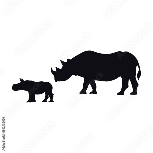 A silhouette of a rhinoceros and its calf standing together in a plain view from the side