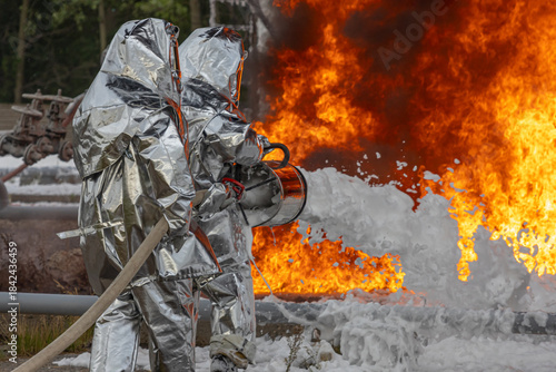 Firefighters use a foam generator to supply foam to extinguish the fire. A fire at the plant caused by the ignition of an oil product. Firefighters extinguish a fire at an oil refinery.