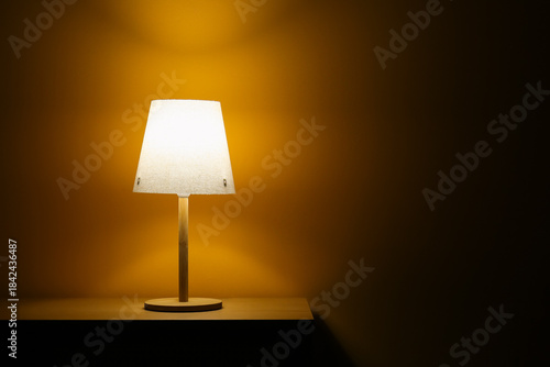 Glowing lamp on wooden tabl...