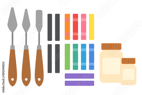 Flat lay of professional painting equipment including palette knives, colorful pigment sticks, and art paste
