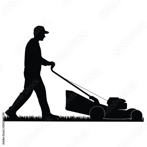 A silhouette of a man mowing the lawn on a sunny day