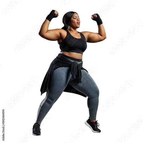 Curvy Black woman in sporty attire, flexing arms and exuding power, representing fitness and strength.