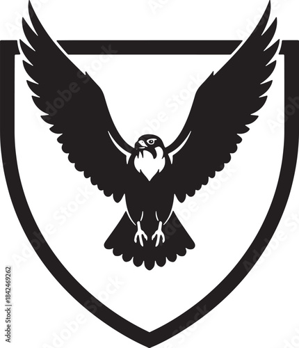 Black silhouette of a falcon in flight within a shield