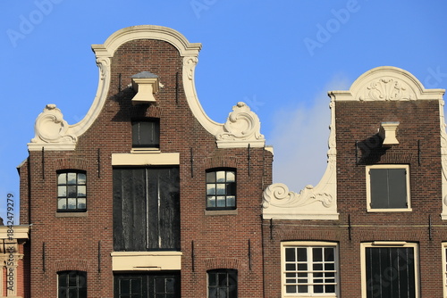 Photography Brown Brick House Facades with Decorated Gables Close Up in Amsterdam, Netherlan