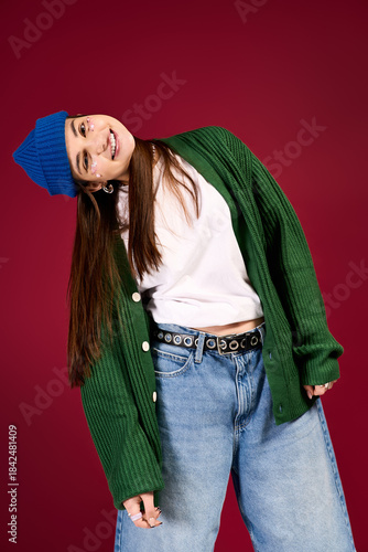 Trendy teenage girl showcases winter style in vibrant studio setting