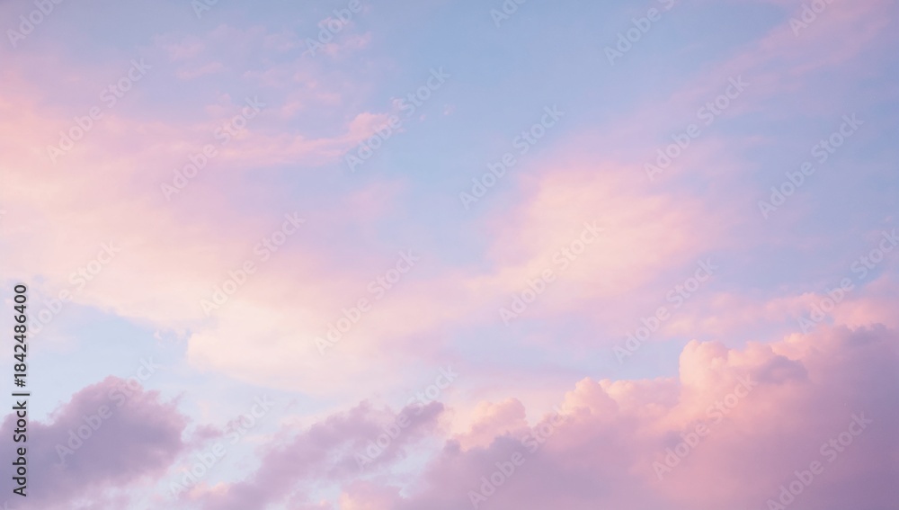 Obraz premium Filling frame pastel clouds over open sky showing layers at dawn, with warm sunlight