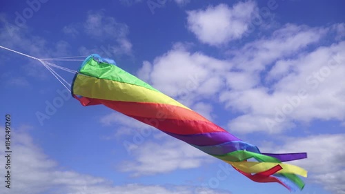 Rainbow Fabric Windsock Fluttering in the Blue Sky.