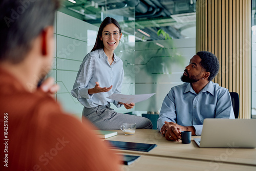 Obraz na plátně Professionals collaborating during a meeting in a modern office, a woman present