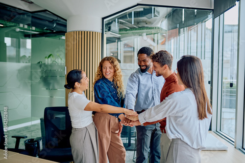 Canvas Print Diverse business professionals joining hands, symbolizing collaboration, teamwor